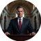 Circular portrait avatar of Tommy Carcetti at a press podium